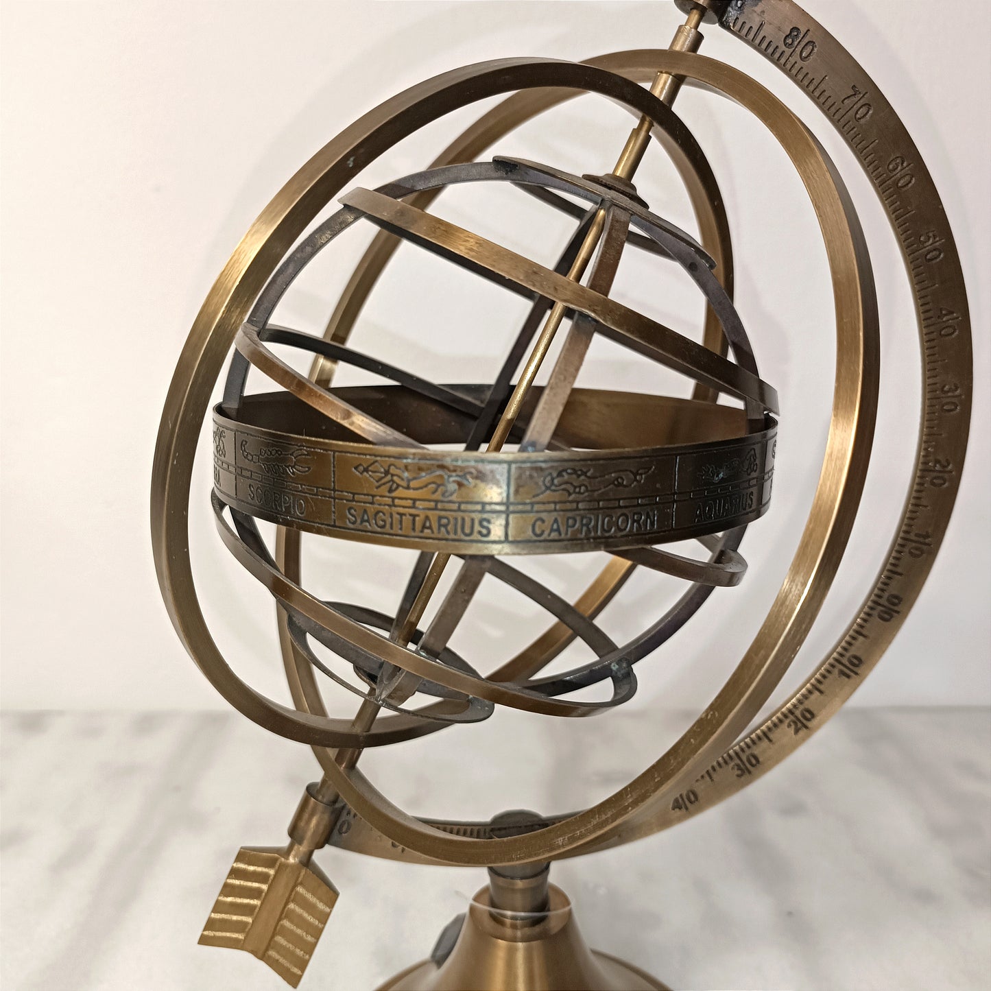 Brass globe with arrow
